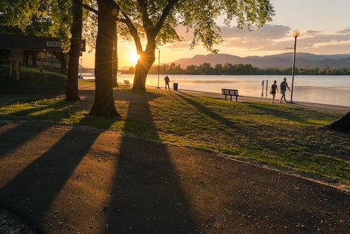 people walking along river in park downtown Kamloops